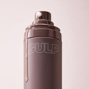 Brown water bottle with 'GULP' branding on a light pink background